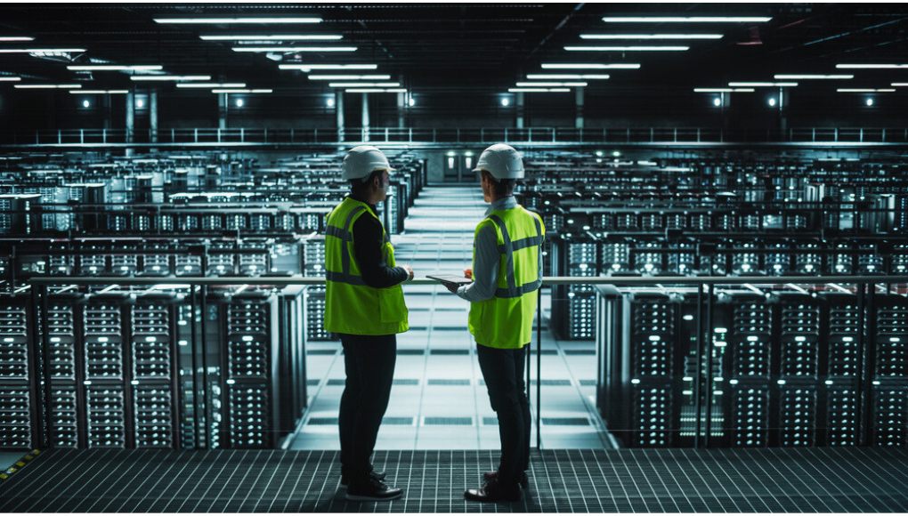Two engineers standing and doing data center management